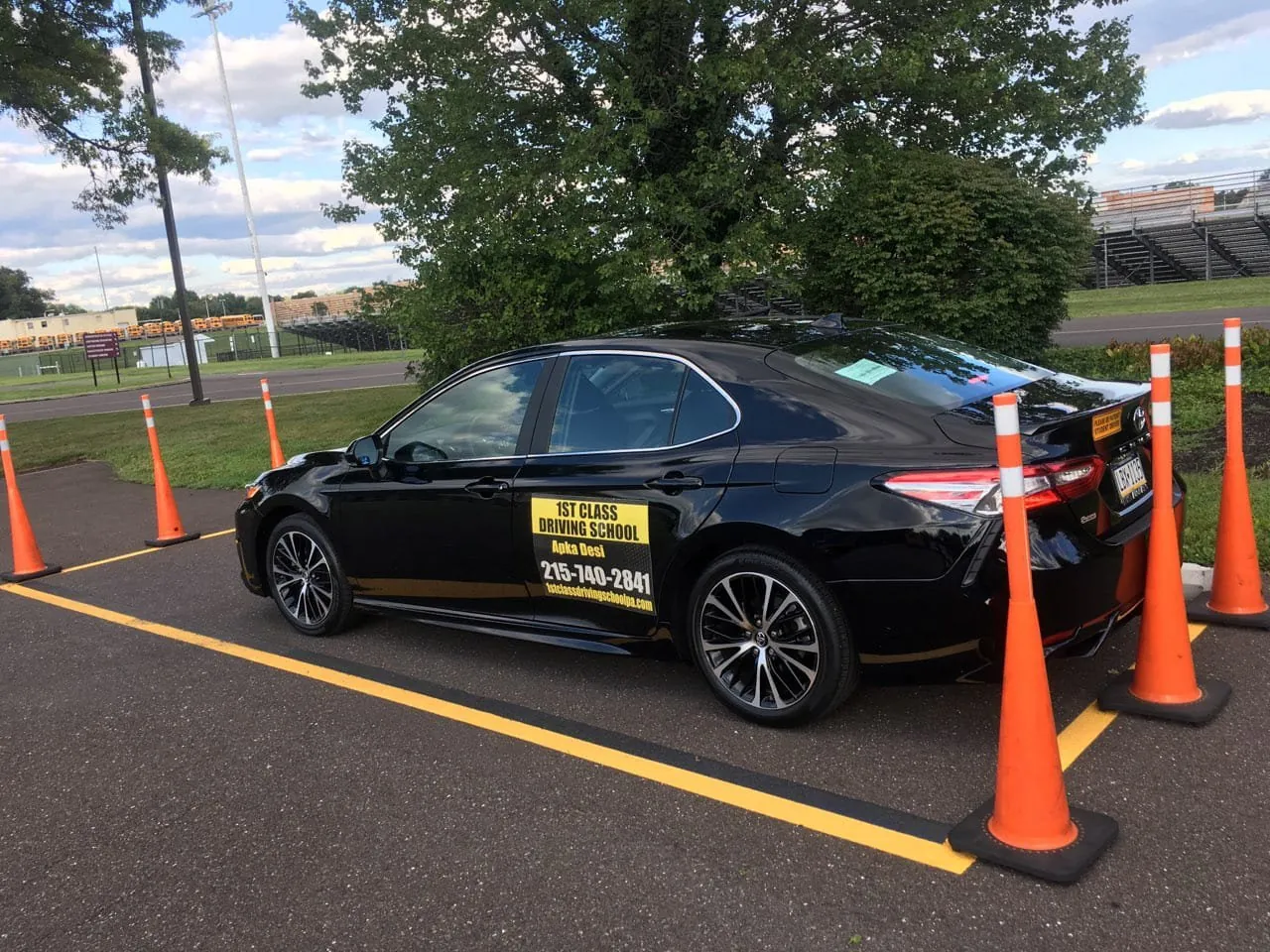 Training car positioned between orange cones during parallel parking practice