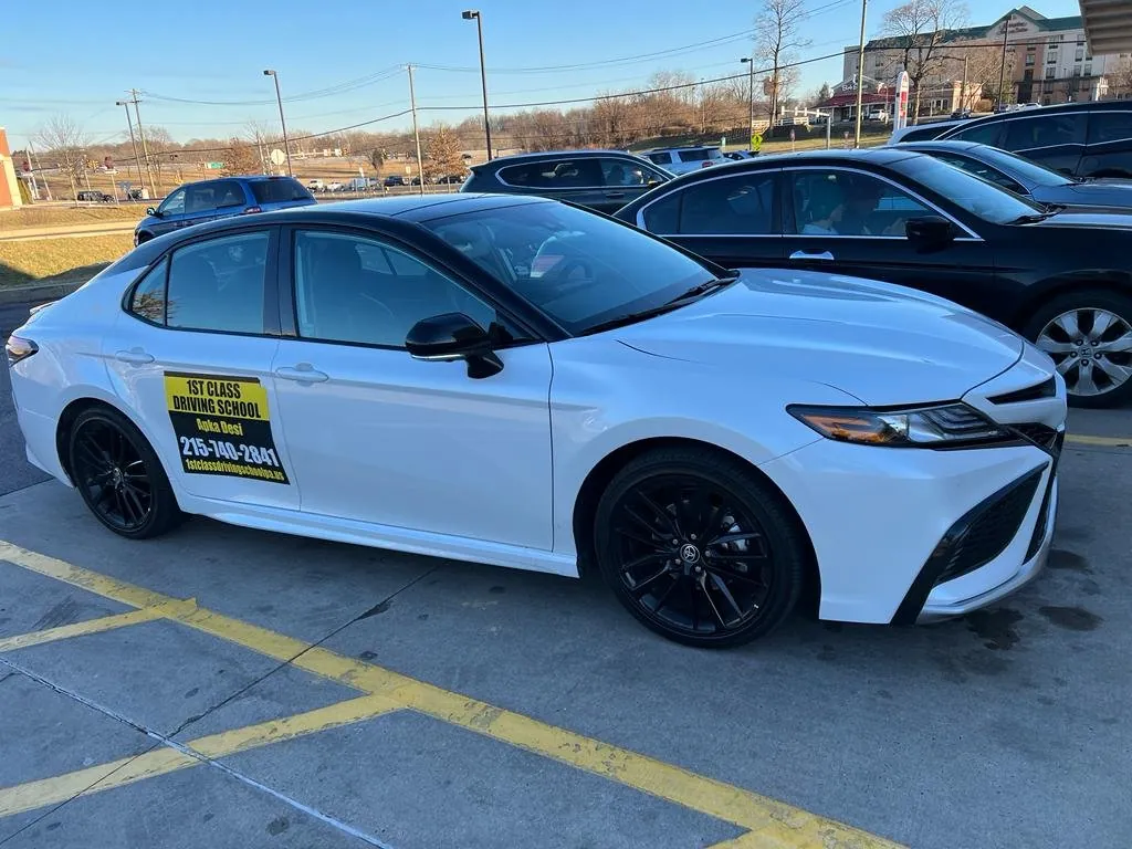 White driving-school Camry parked among cars in Greater Philadelphia