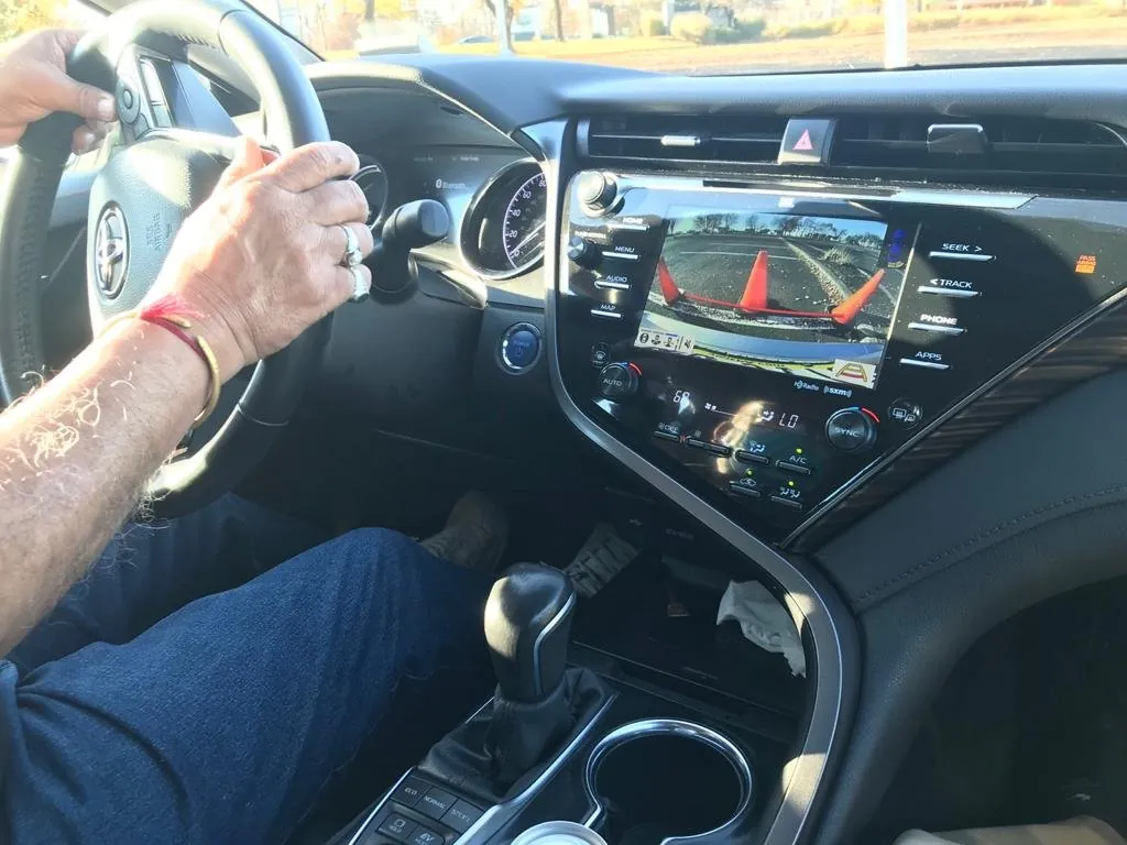 Student's hands positioned on the wheel ready to steer through a roundabout