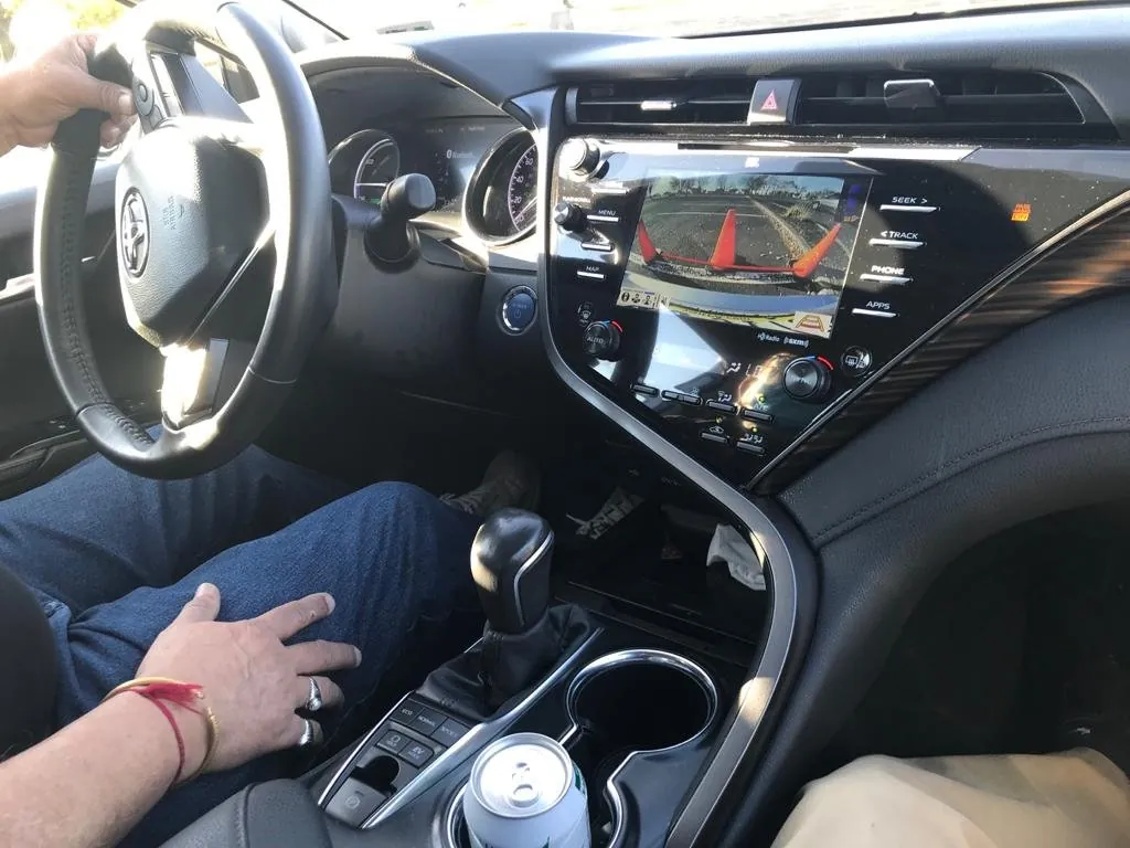 Student's hand on the gear selector during a lesson