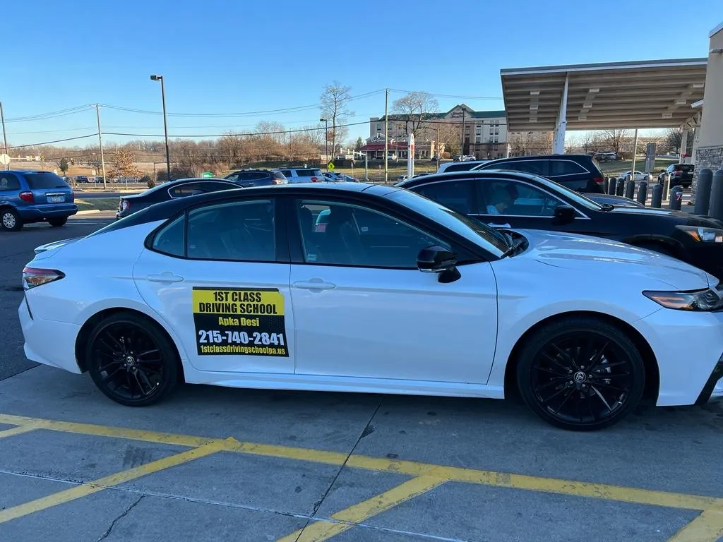 White driving-school car parked outside a Pennsylvania business