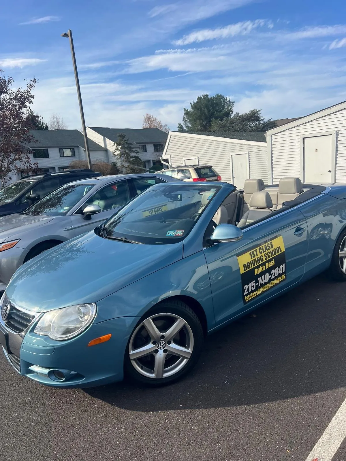 Light blue training car parked in a lot used for lesson pickups