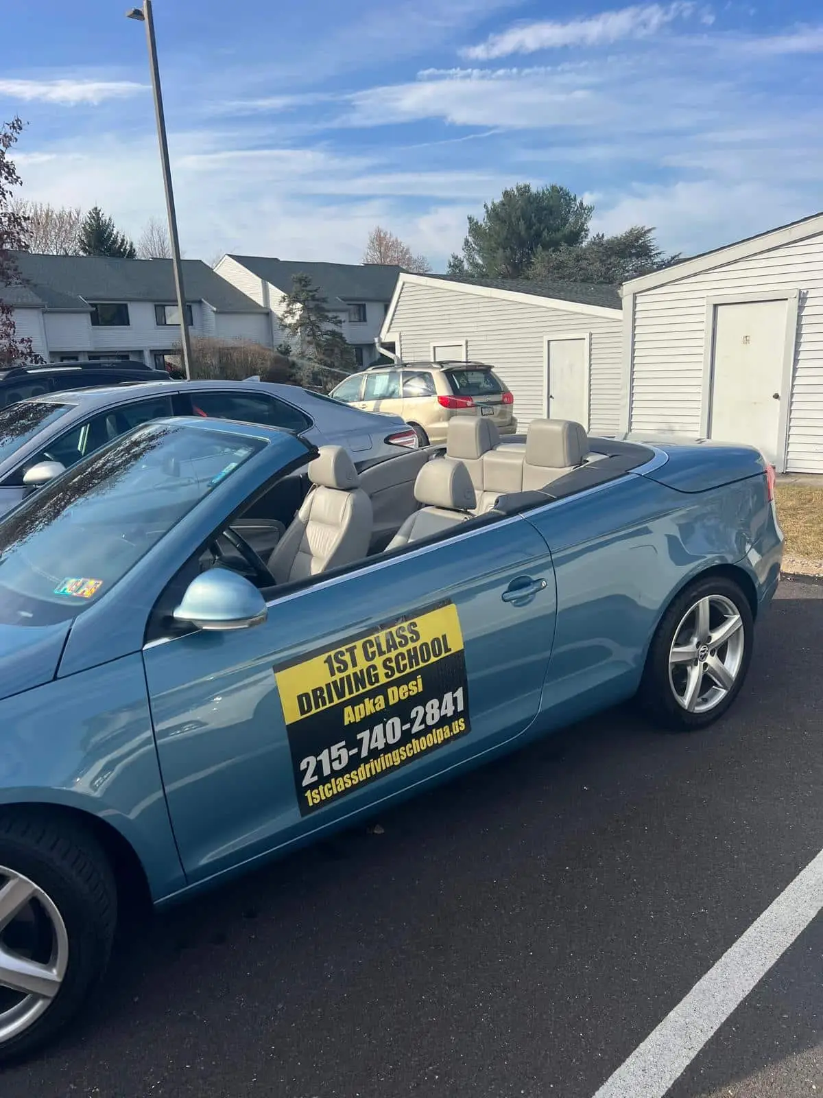 Close view of the driving-school door signage on a training car