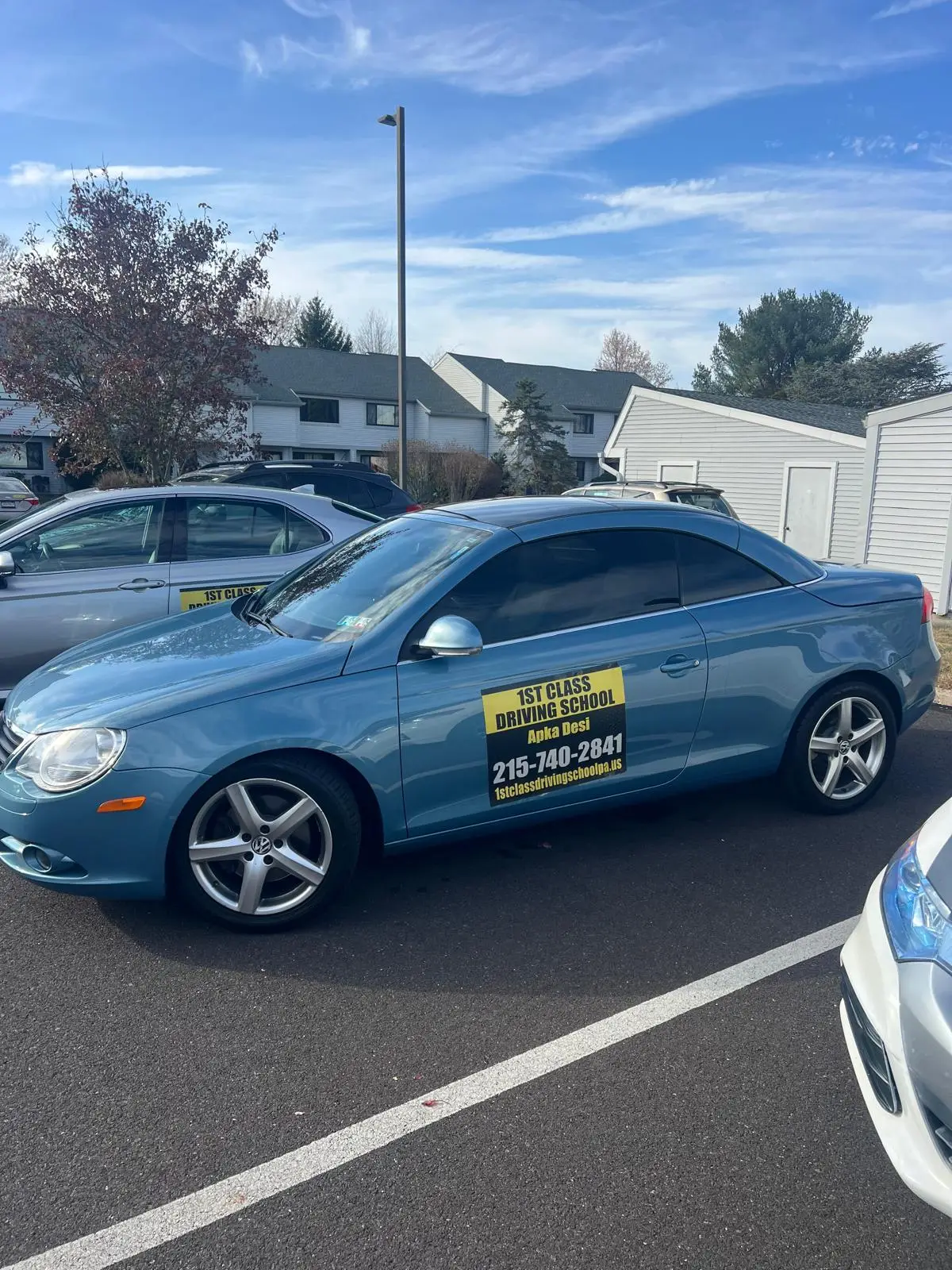 Dark training car alongside another vehicle in a practice lot
