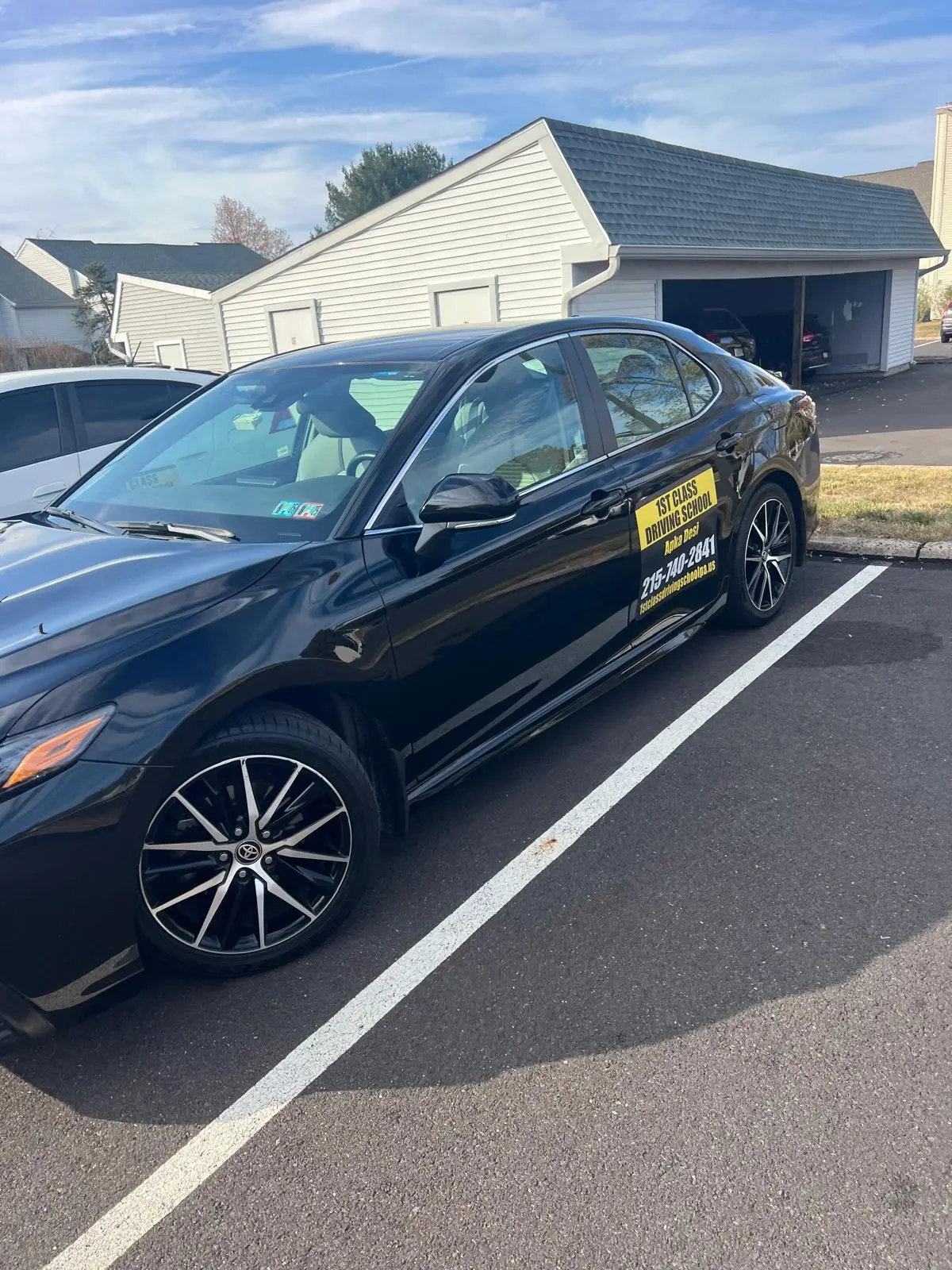 Black Toyota Camry from the training fleet in a marked bay