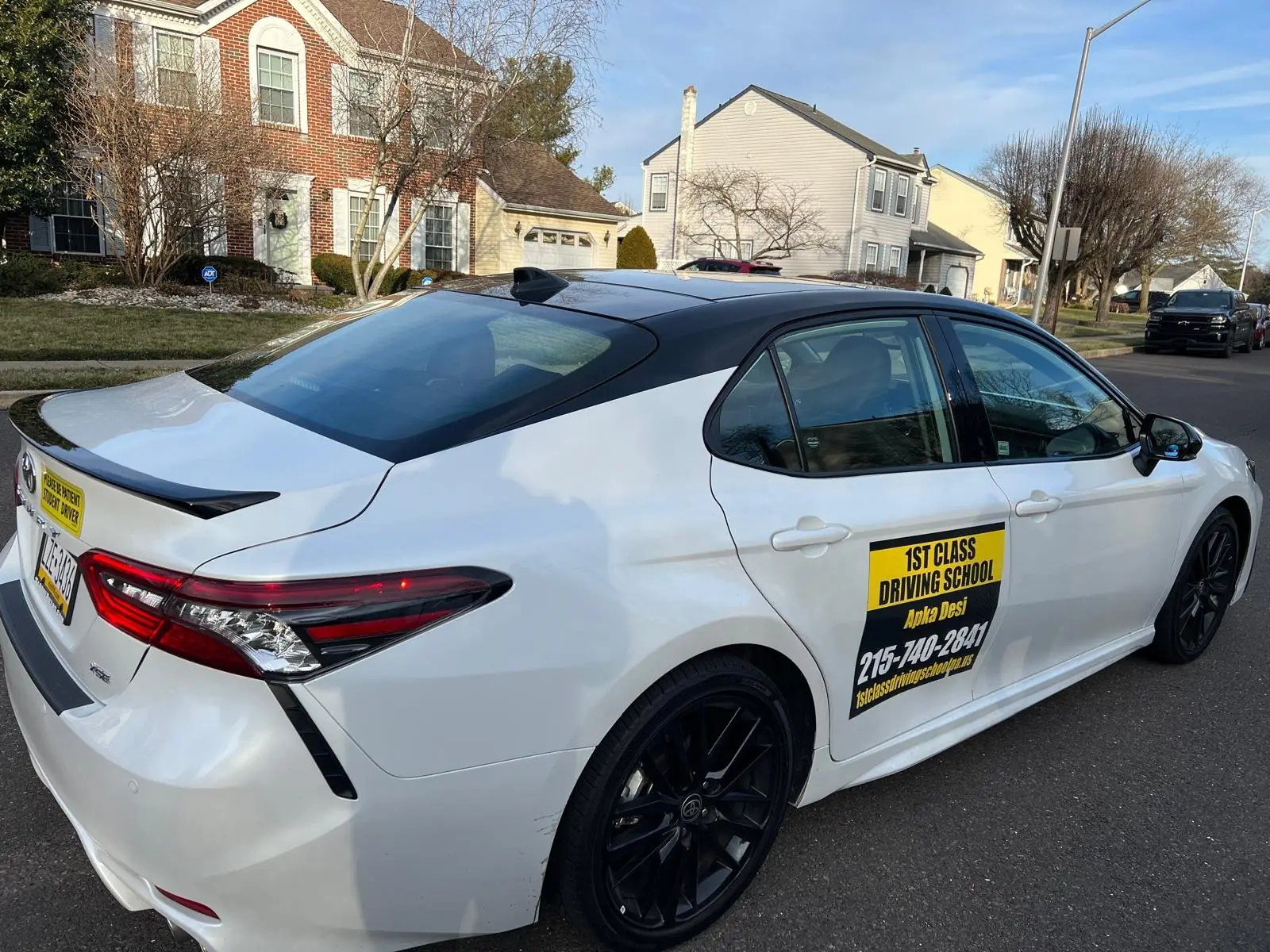 Training car at the curb on a narrow residential street